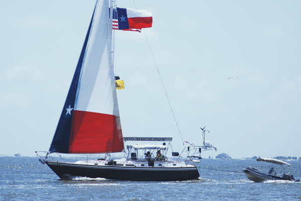 Showing a sailboat with a Texas flag design for the sail.